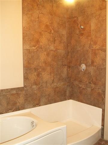 The all in one tub & shower unit will have two sided clear glass.